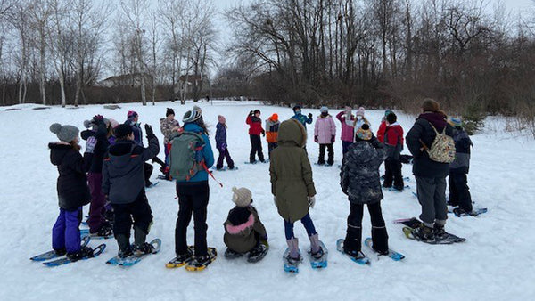 school group learning how to snowshoe