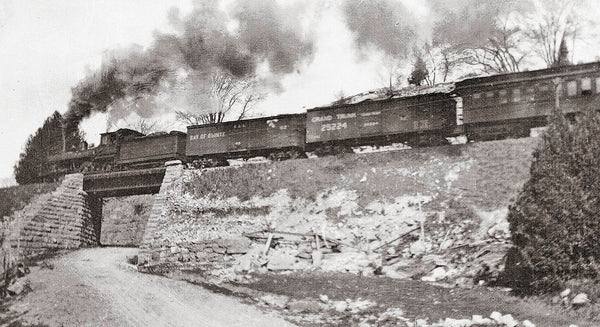 historical photo of a train on on a bridge