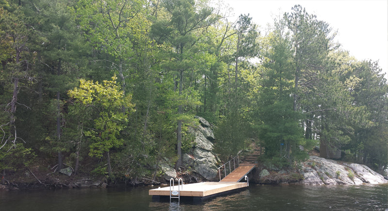 floating dock on a lake with a forest in the background