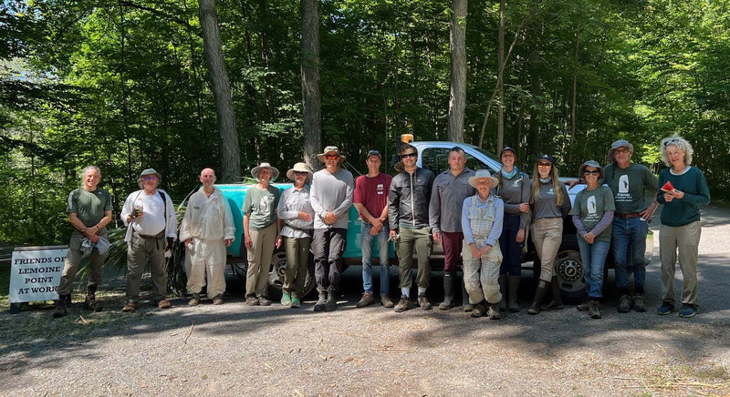volunteers standing by a truck for a photo