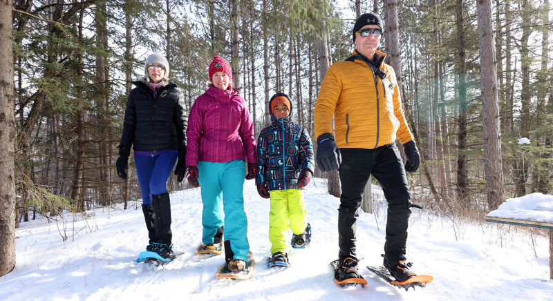 people snowshoeing on a trail