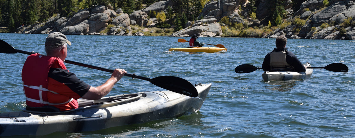 people kayaking on a lake